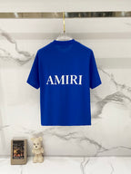 Blue crewneck T-shirt with large white AMIRI text on chest