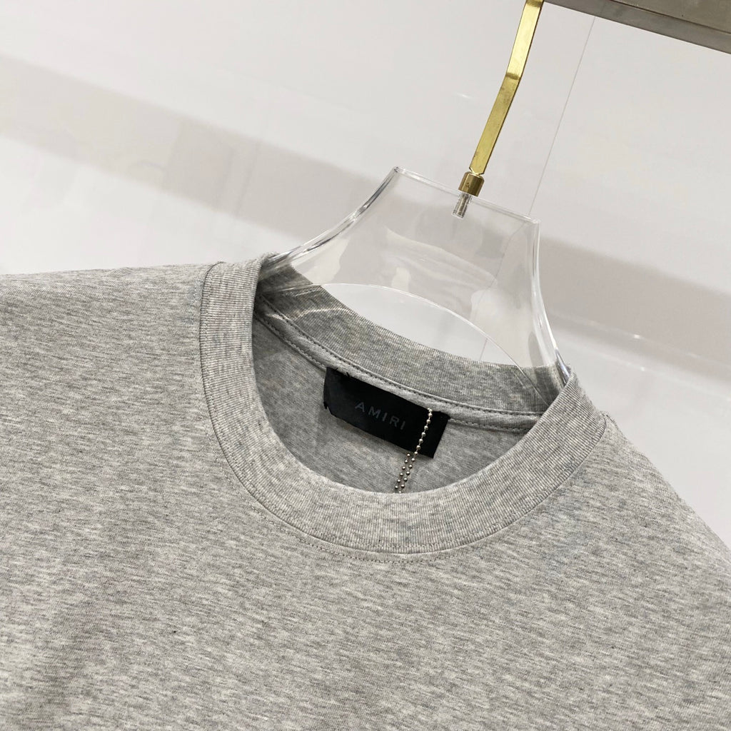 Amiri heather gray crewneck T-shirt with inner black brand label at collar