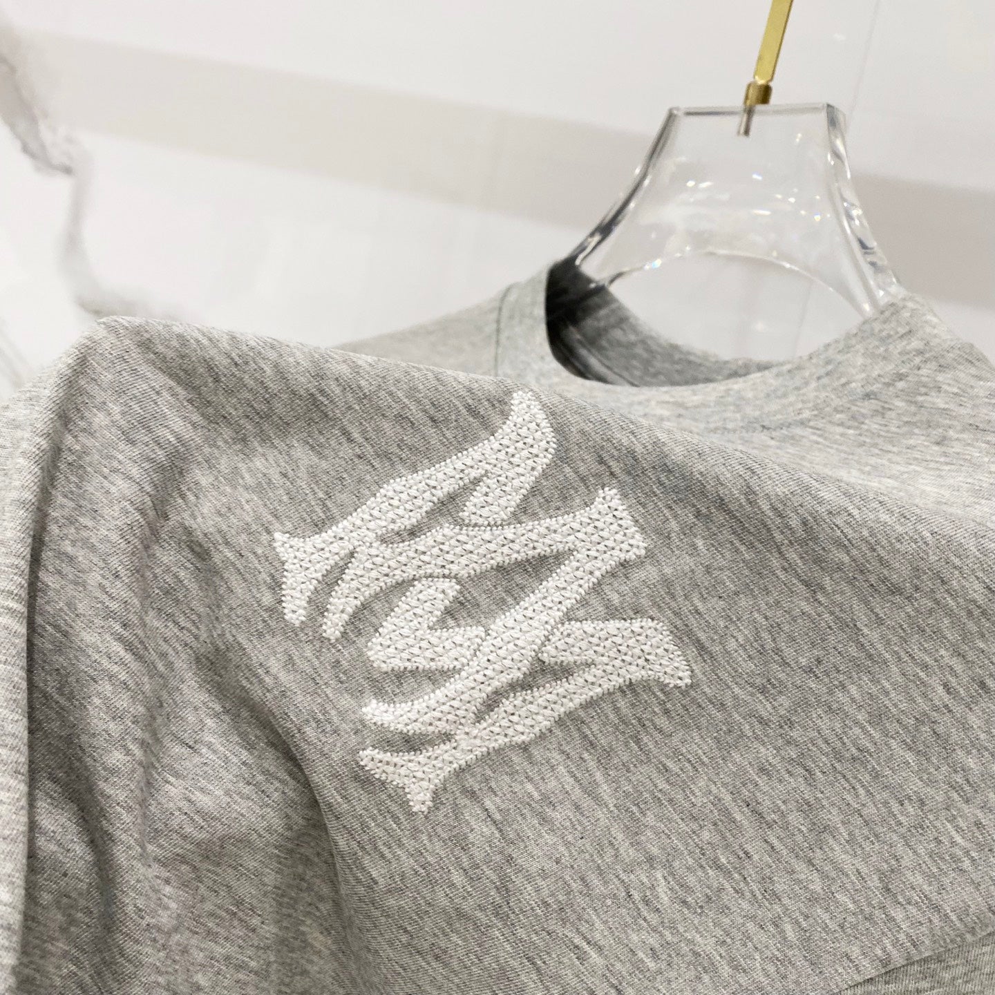 Amiri heather gray crewneck T-shirt with white graphic motif on front