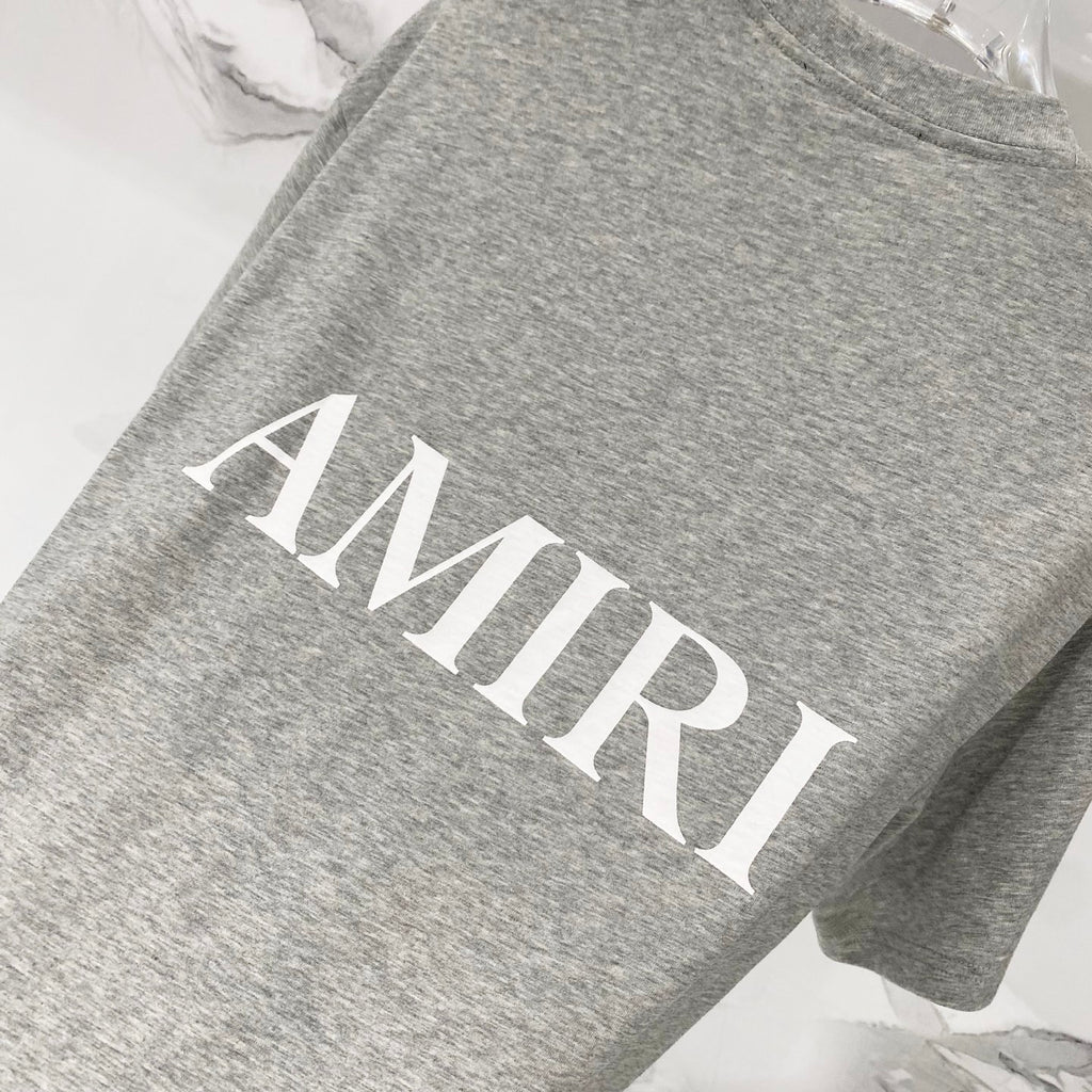 Amiri heather gray crewneck T-shirt with large white AMIRI logo print