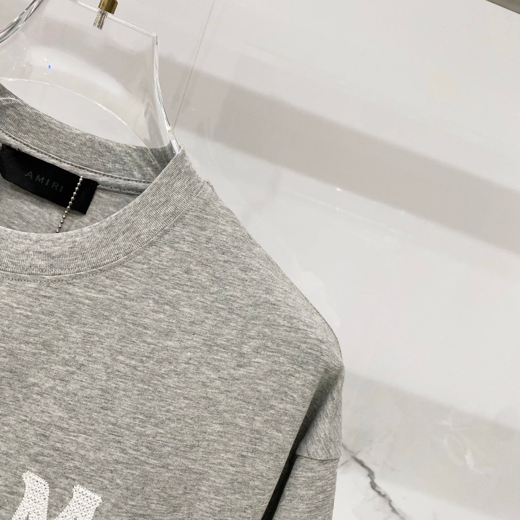 Amiri heather gray crewneck T-shirt with short sleeves and side seam detail
