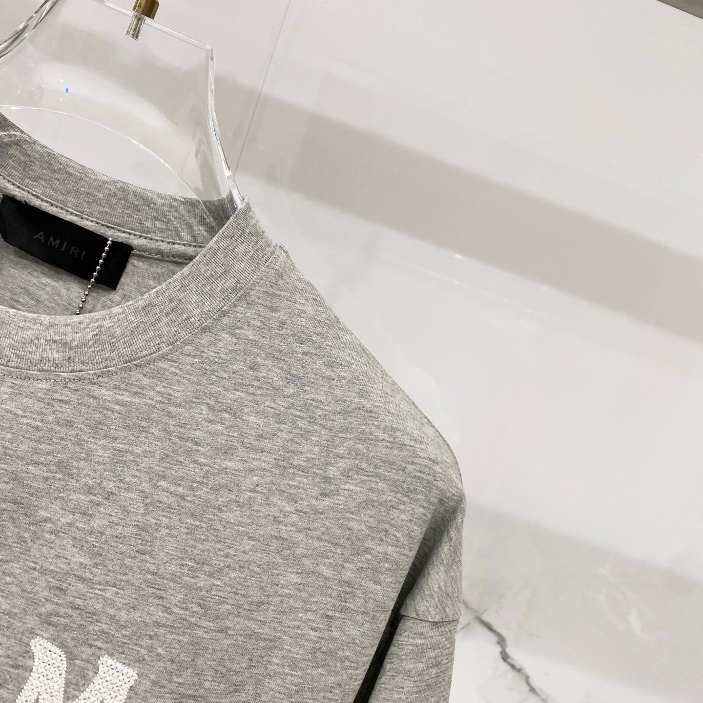 Amiri heather gray crewneck T-shirt with short sleeves and side seam detail