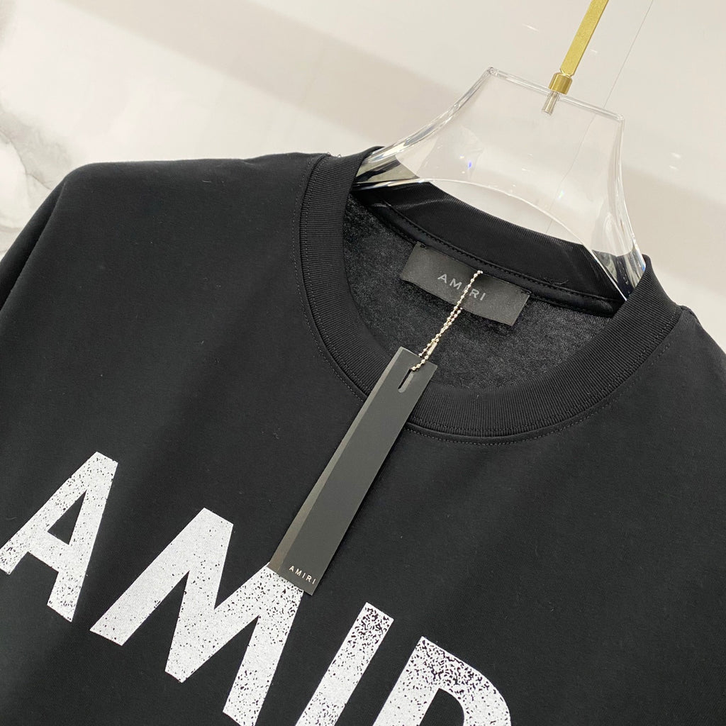 Black T-shirt with crew neck and small AMIRI neck label