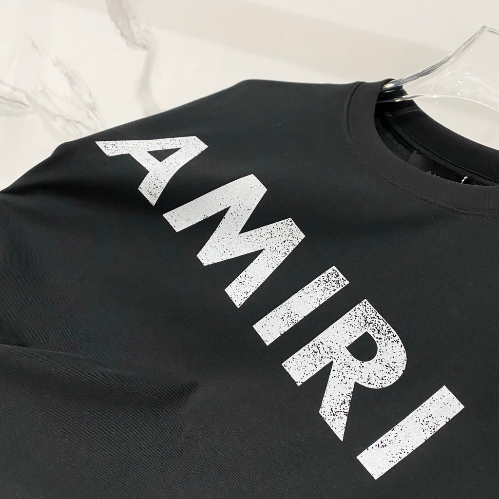 Large white AMIRI logo print on black T-shirt, crew neck