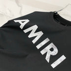 Large white AMIRI logo print on black T-shirt, crew neck