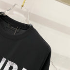 Black T-shirt collar with AMIRI neck label detail