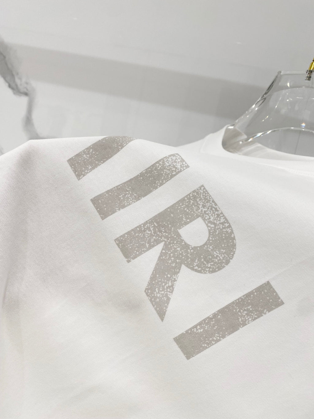 White crewneck T-shirt with large AMIRI lettering graphic