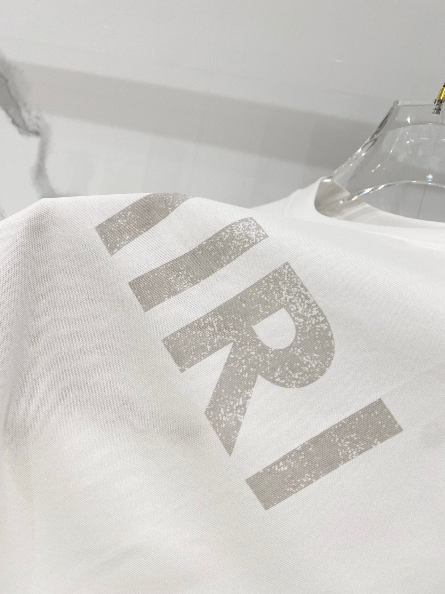 White crewneck T-shirt with large AMIRI lettering graphic