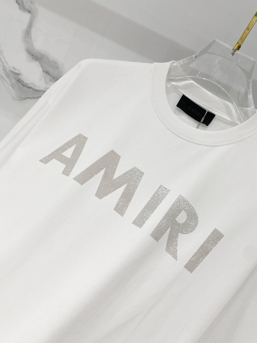 White crewneck T-shirt with large AMIRI logo graphic across chest
