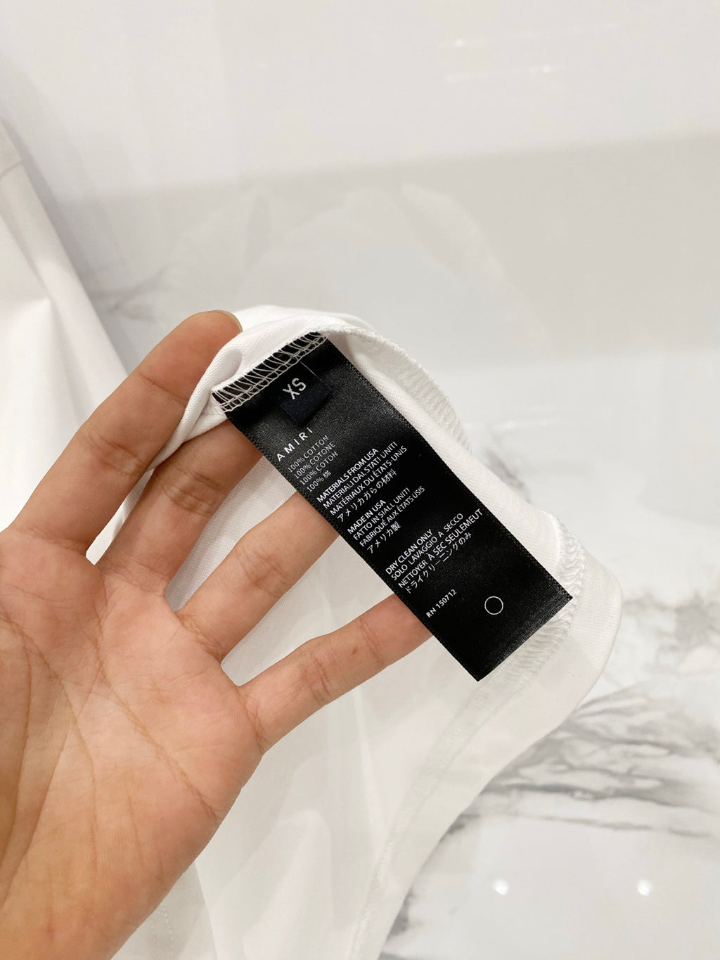 White crewneck T-shirt size tag and care label on the inside neck