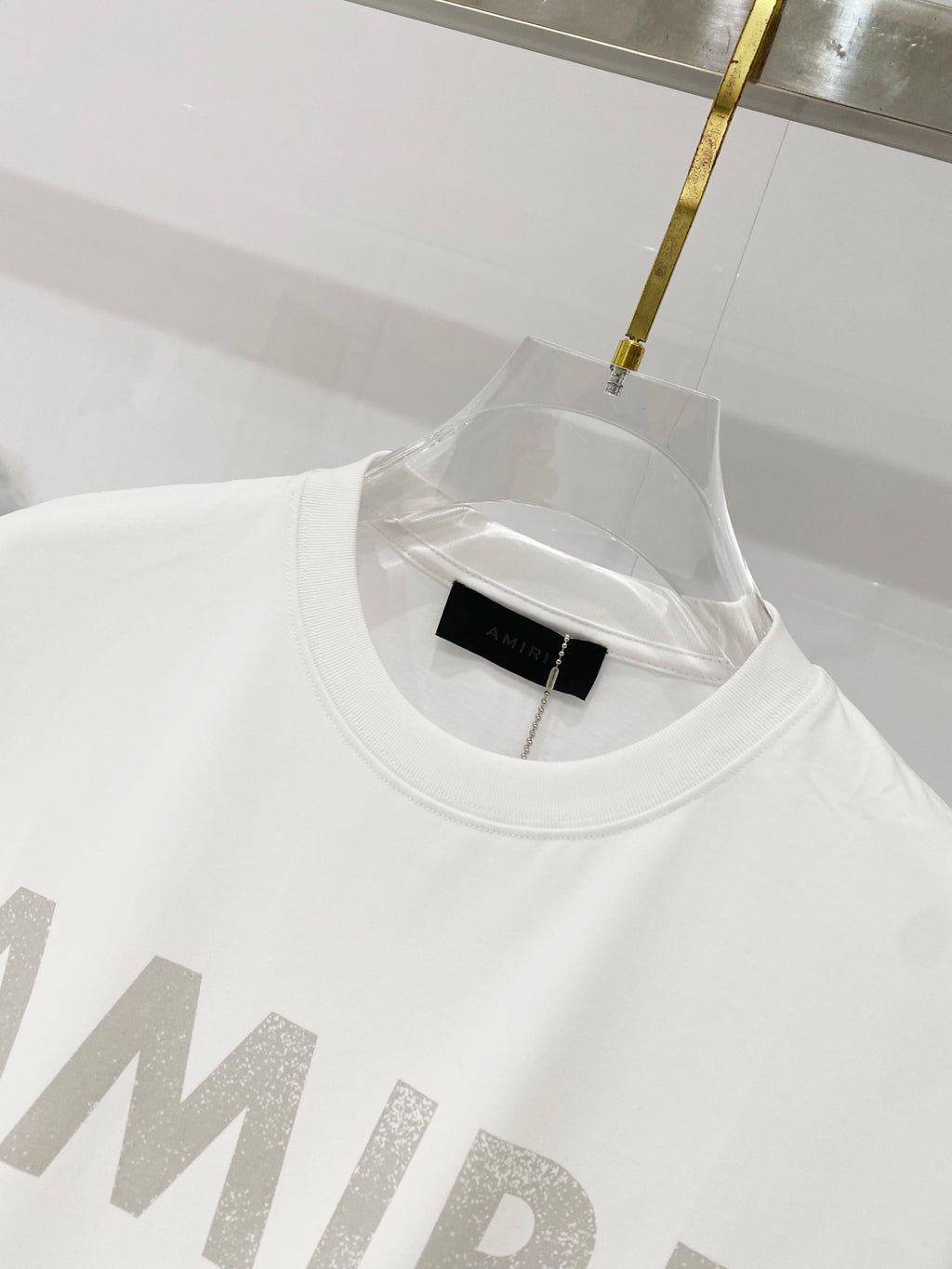 White crewneck T-shirt close-up at neckline with black size tag