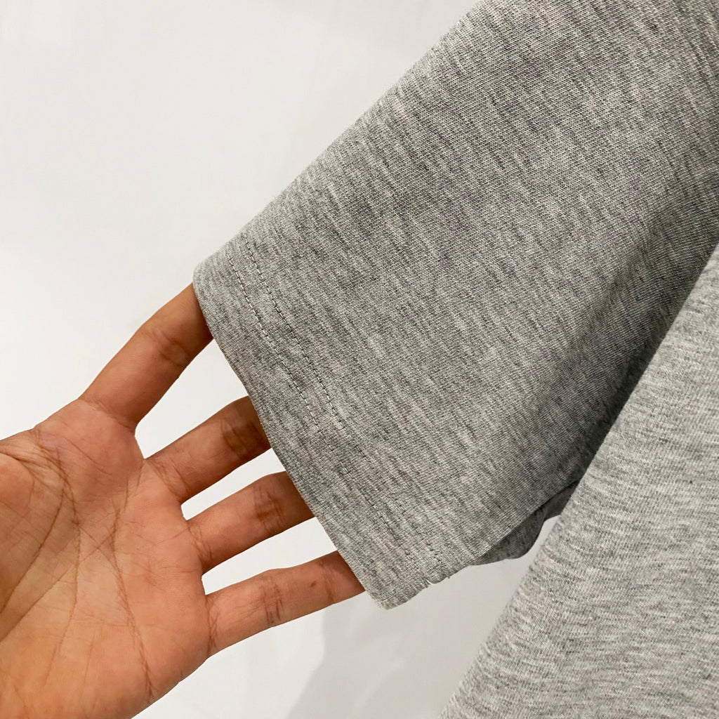 Amiri heather gray T-shirt fabric close-up with short-sleeve hem