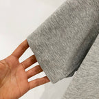 Amiri heather gray T-shirt fabric close-up with short-sleeve hem