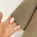 Olive T-shirt sleeve hem with visible double stitching and fabric weave