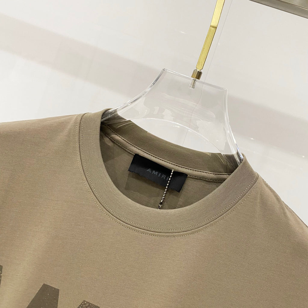 Olive T-shirt collar close-up with inner neck label under hanger