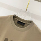 Olive T-shirt collar close-up with inner neck label under hanger