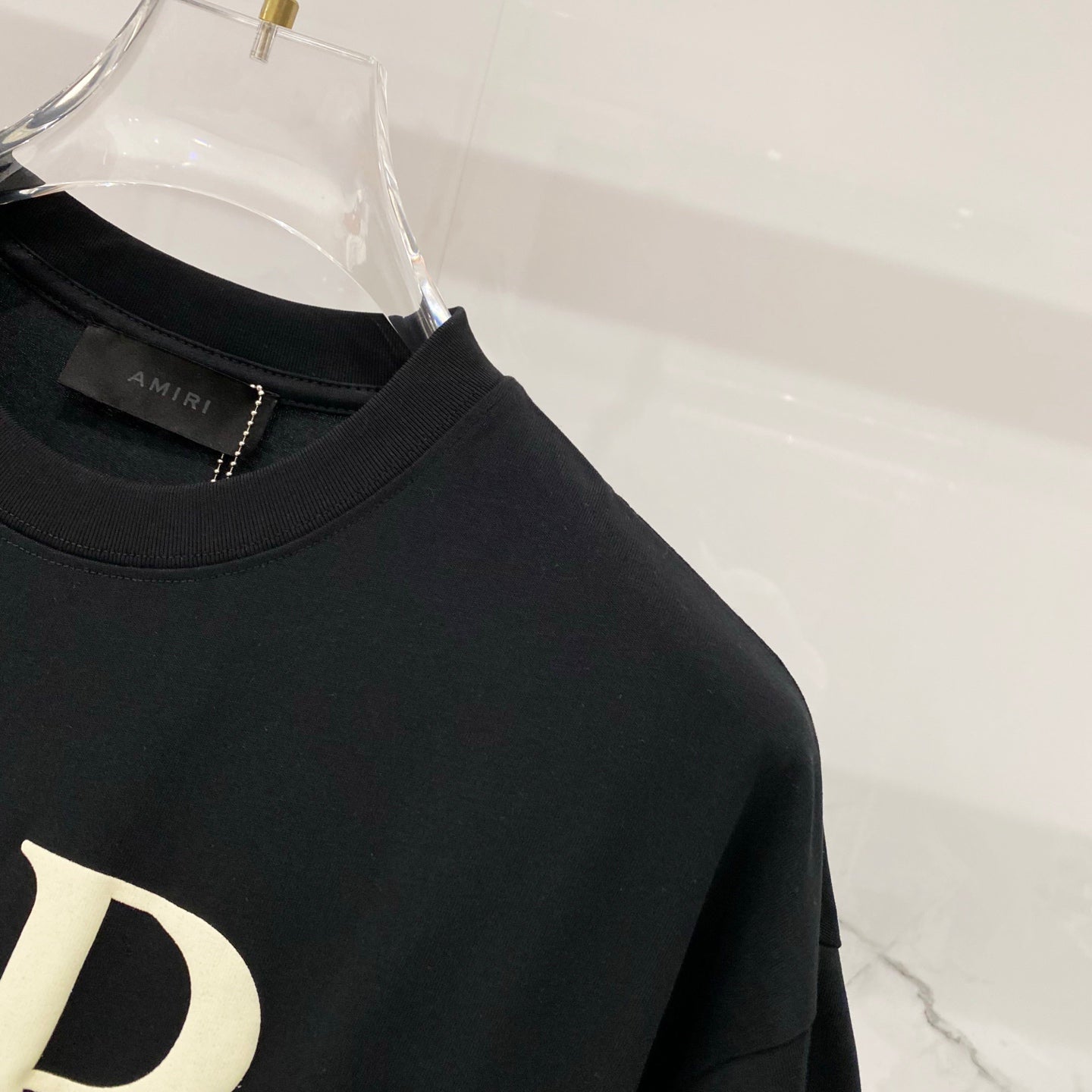 Black Amiri T-shirt shoulder and neckline seam close-up