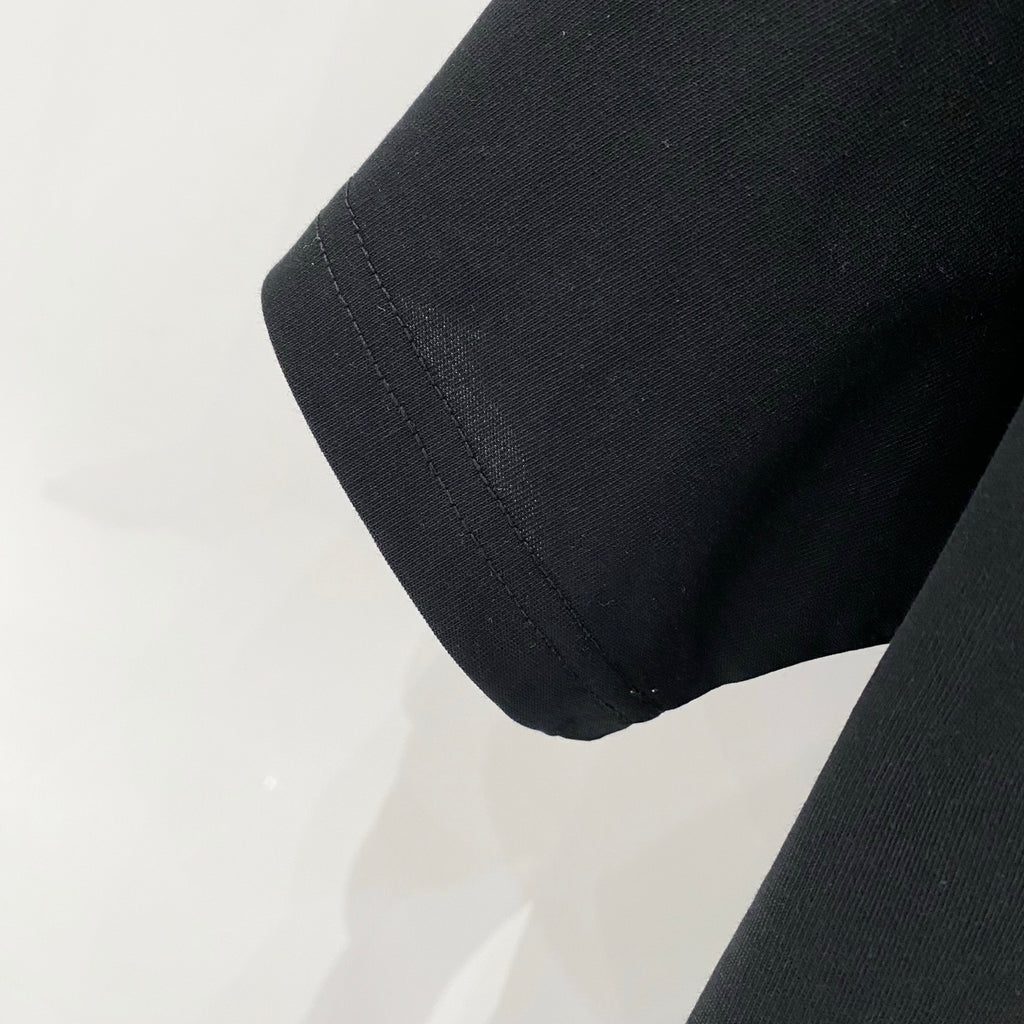 Black Amiri T-shirt sleeve cuff and hem stitching close-up