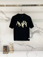Black Amiri T-shirt with large cream AMIRI logo on the chest