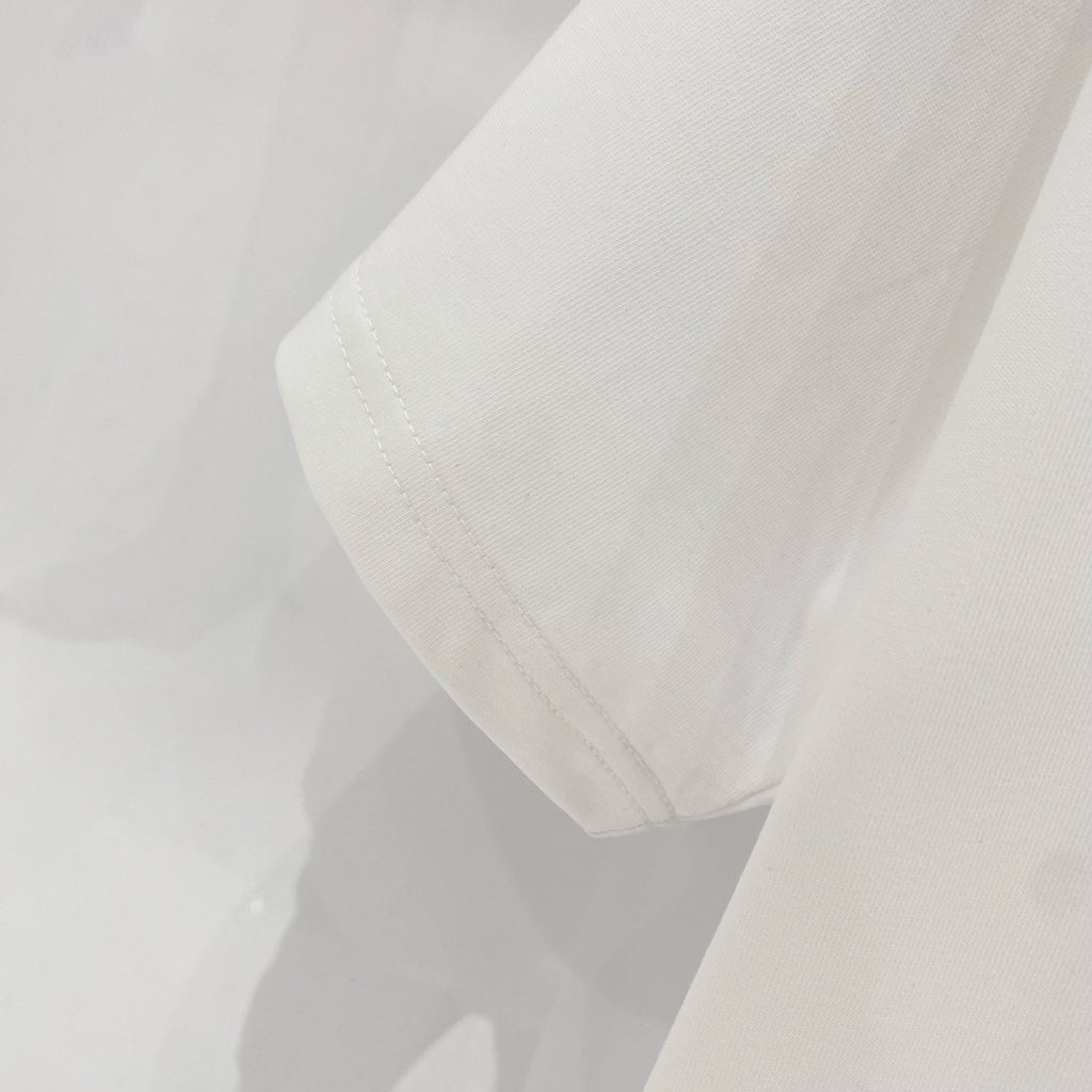 White T-shirt showing side seam and hem stitching detail.