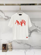White crewneck short-sleeve T-shirt with red AMIRI logo graphic on the front.