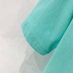 Turquoise T-shirt sleeve hem with visible stitching