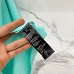 Turquoise T-shirt care label attached near sleeve edge