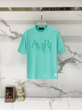 Turquoise crewneck T-shirt with large gray AMIRI logo on the front