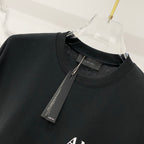 Black crewneck T-shirt neckline with AMIRI label and hanging tag