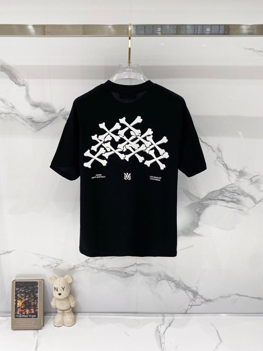 Black crewneck T-shirt with large white graphic print and small text