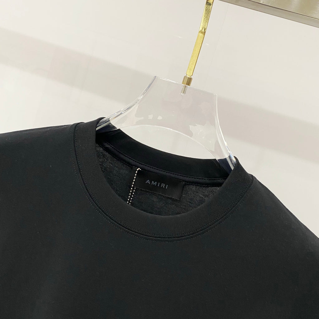 Black crewneck T-shirt collar with inner AMIRI branding label