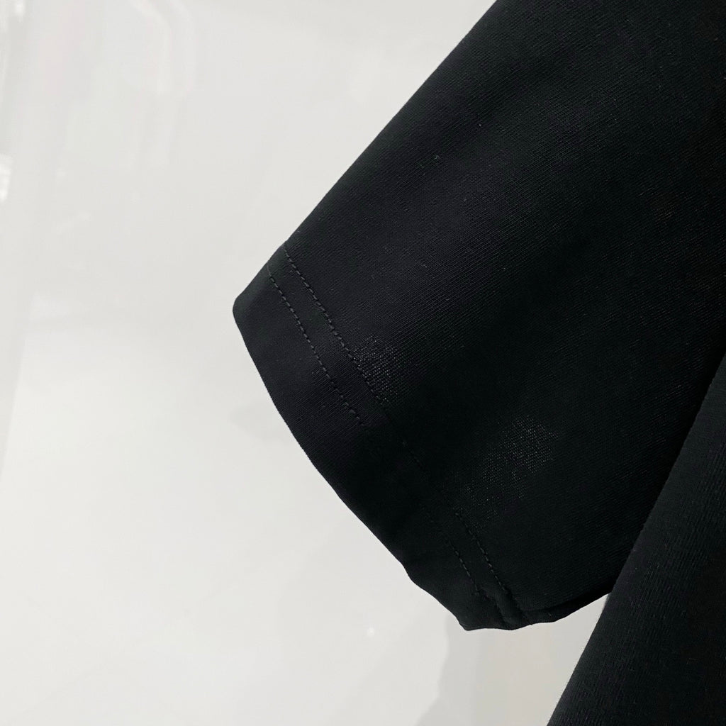 Black T-shirt sleeve hem with visible stitching