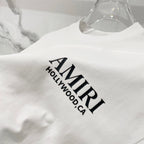 Amiri white T-shirt close-up of AMIRI Hollywood CA logo print