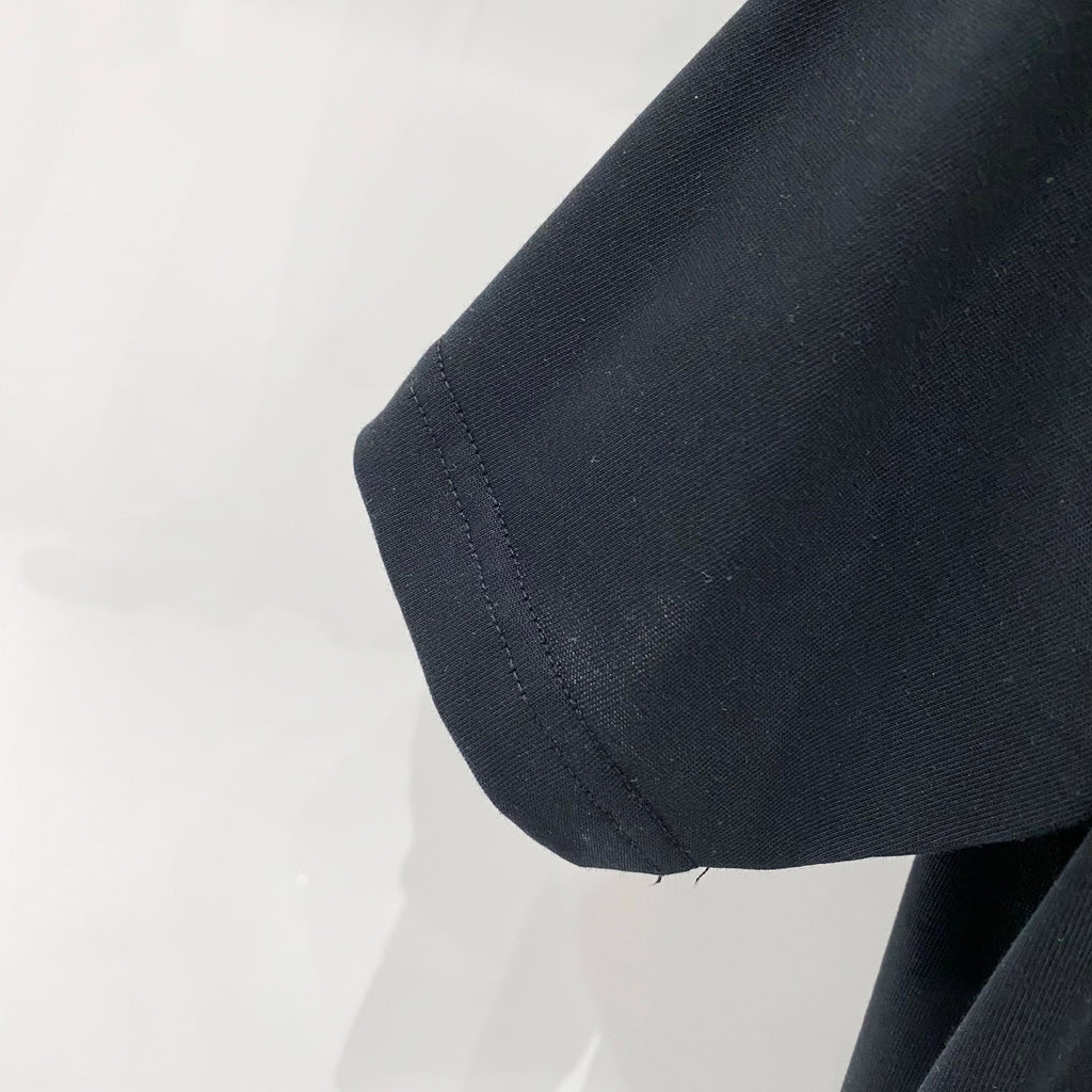 Black T-shirt sleeve hem with stitched side seam detail