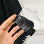 Black T-shirt size and care label tag on the inner hem