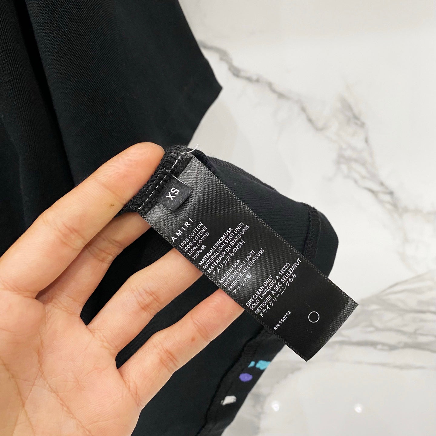 Black T-shirt size and care label tag on the inner hem