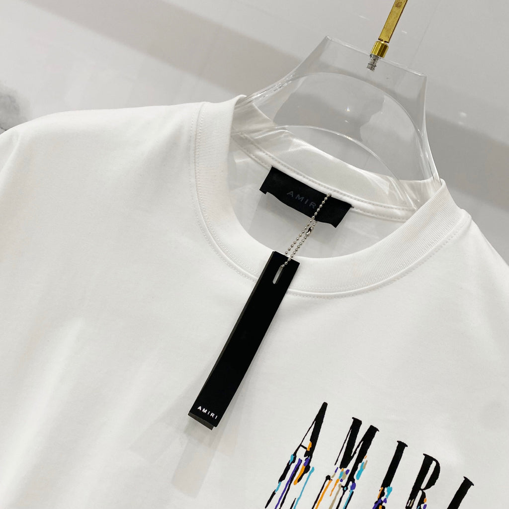 White crewneck T-shirt collar with black tag label and drippy logo graphic