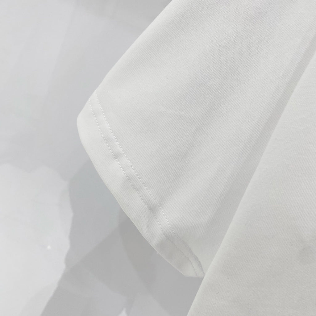 White T-shirt sleeve and side hem with visible stitching
