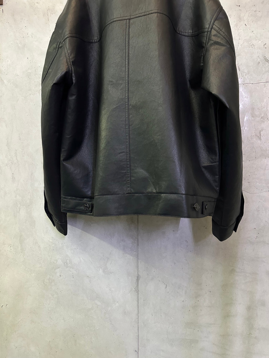 Balenciaga long coat in dark leather-look, back hem with button cuff detail