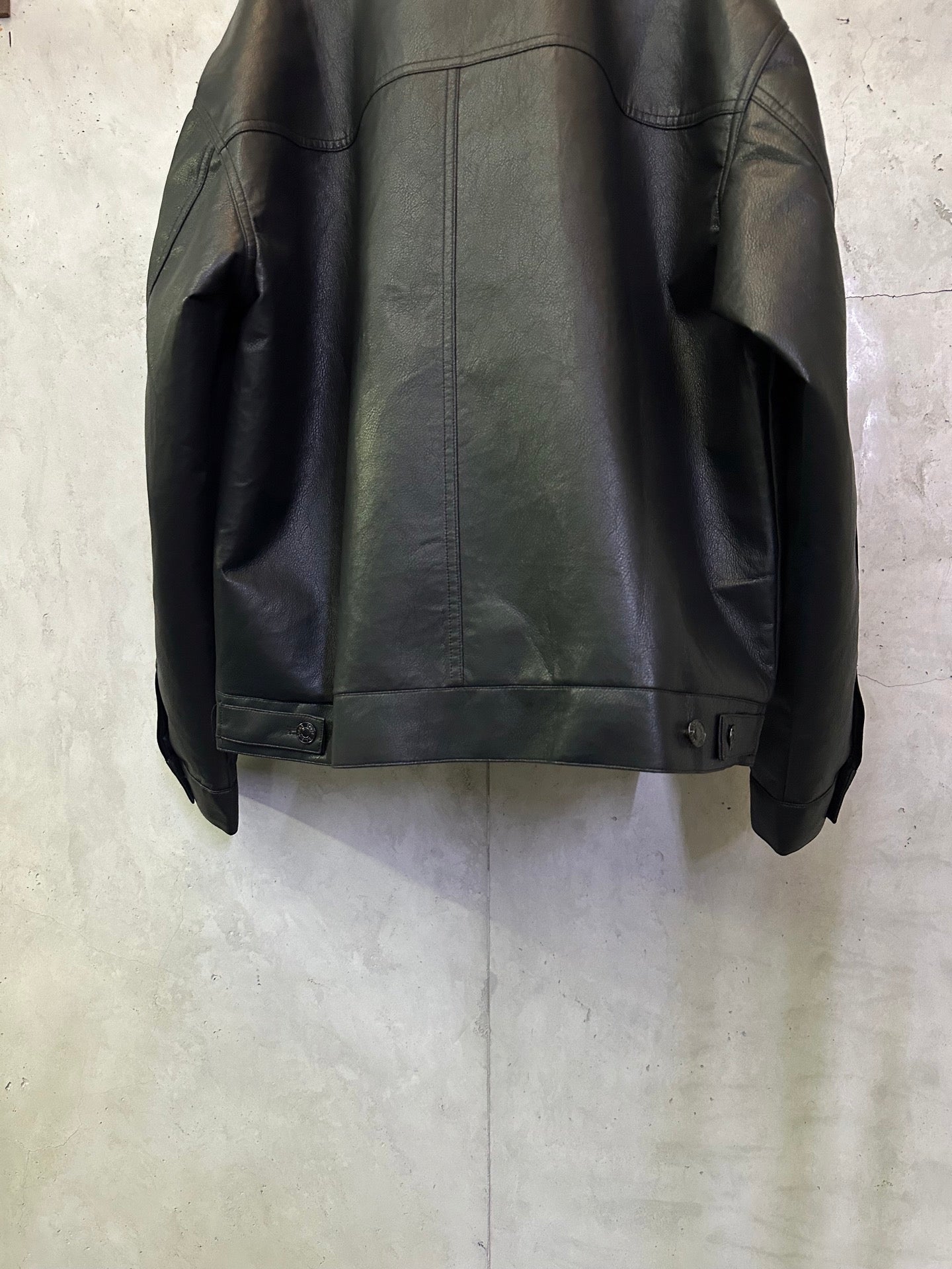 Balenciaga long coat in dark leather-look, back hem with button cuff detail