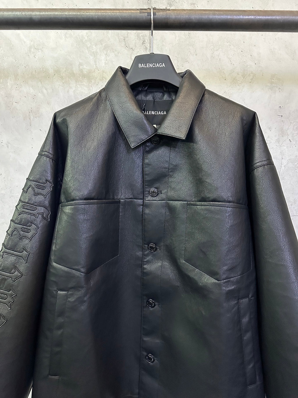 Balenciaga long coat in dark leather-look with chest button front and patch pockets