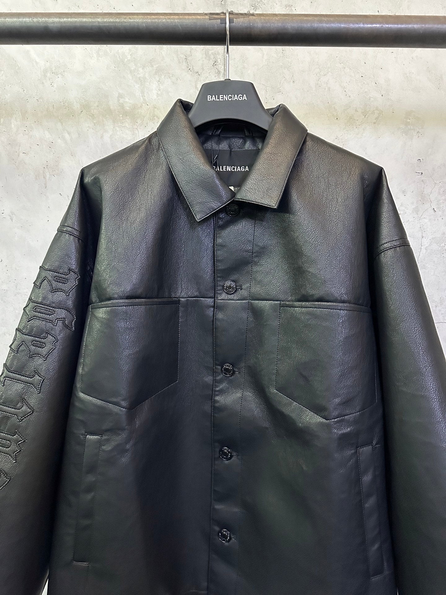 Balenciaga long coat in dark leather-look with chest button front and patch pockets