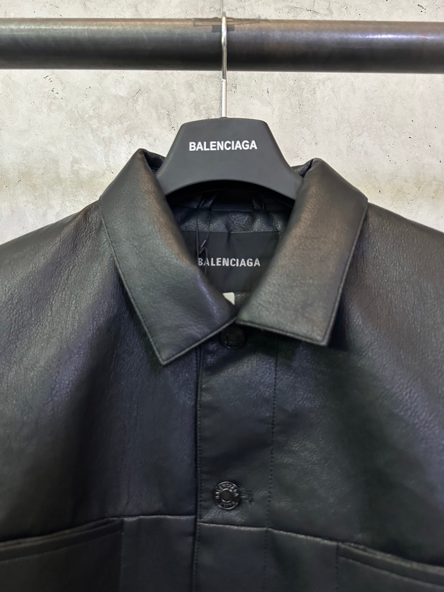 Balenciaga long coat with pointed collar and inner label at neckline, dark leather-look
