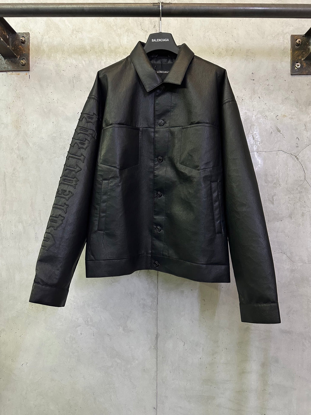 Balenciaga long coat in dark leather-look with pointed collar and button front