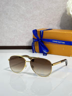 Gold-tone cat-eye sunglasses with tinted brown lenses and rectangular bridge