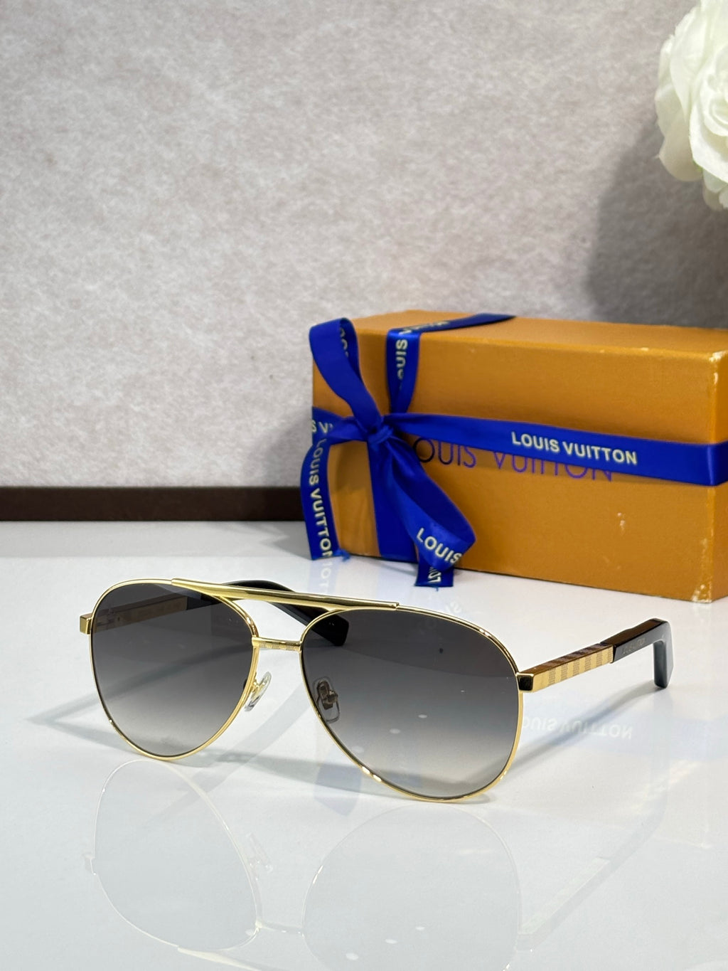 Gold-tone oversized cat-eye sunglasses with smoke-brown lenses and metal temples