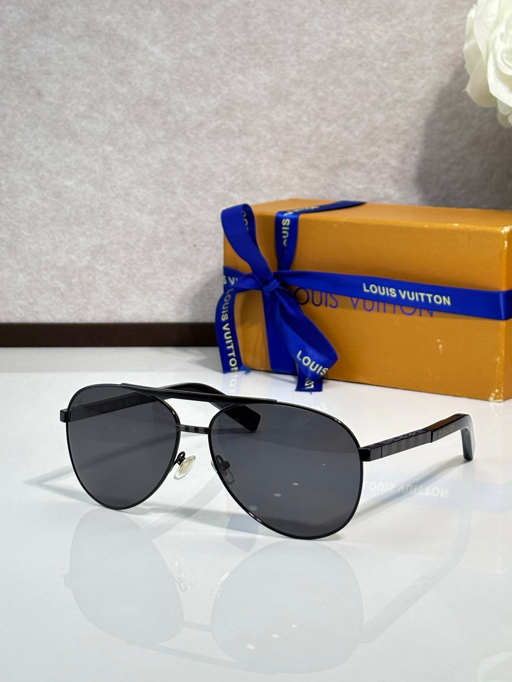 Black cat-eye sunglasses with dark lenses and metal temples