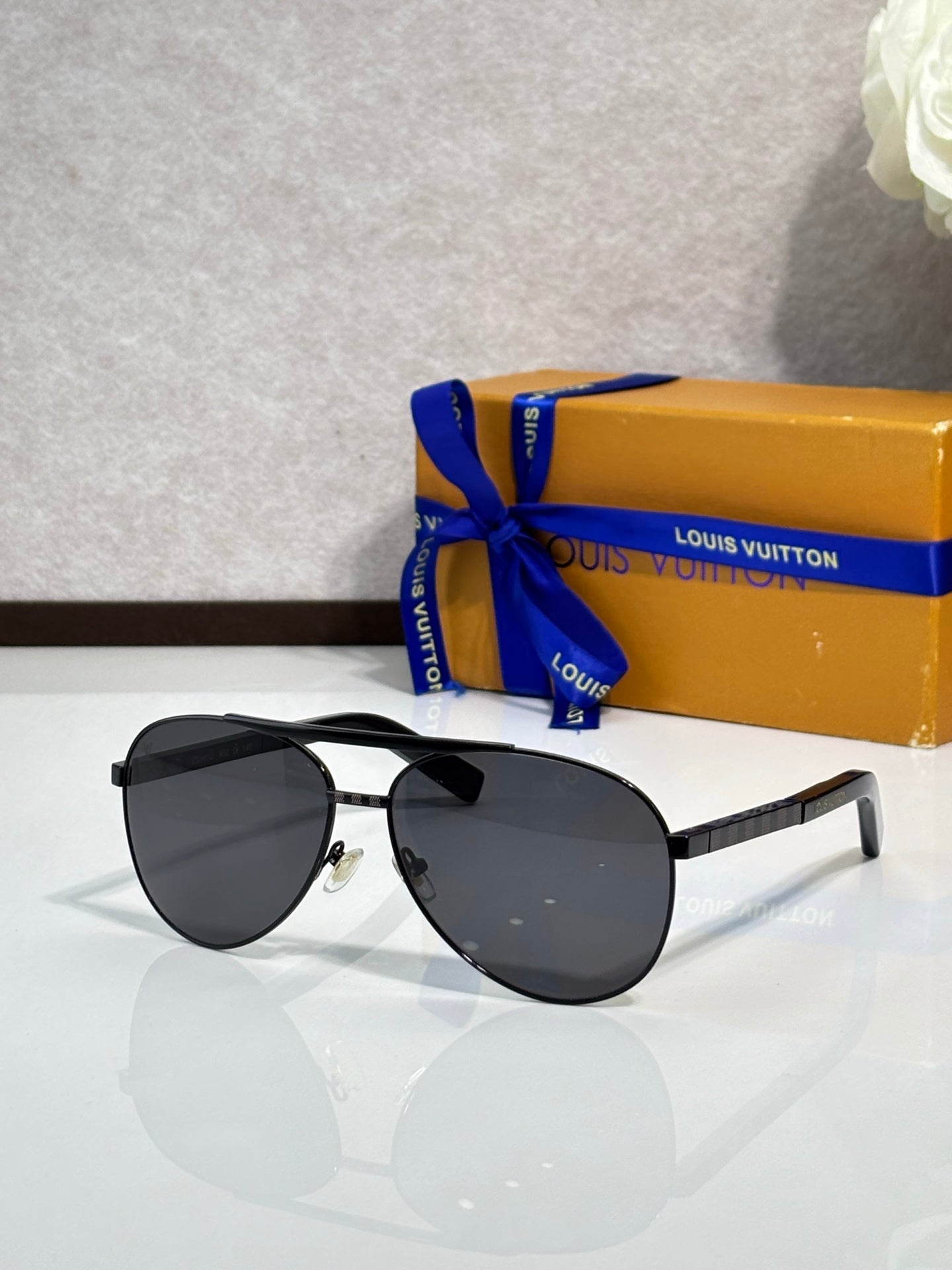 Black cat-eye sunglasses with dark lenses and metal temples