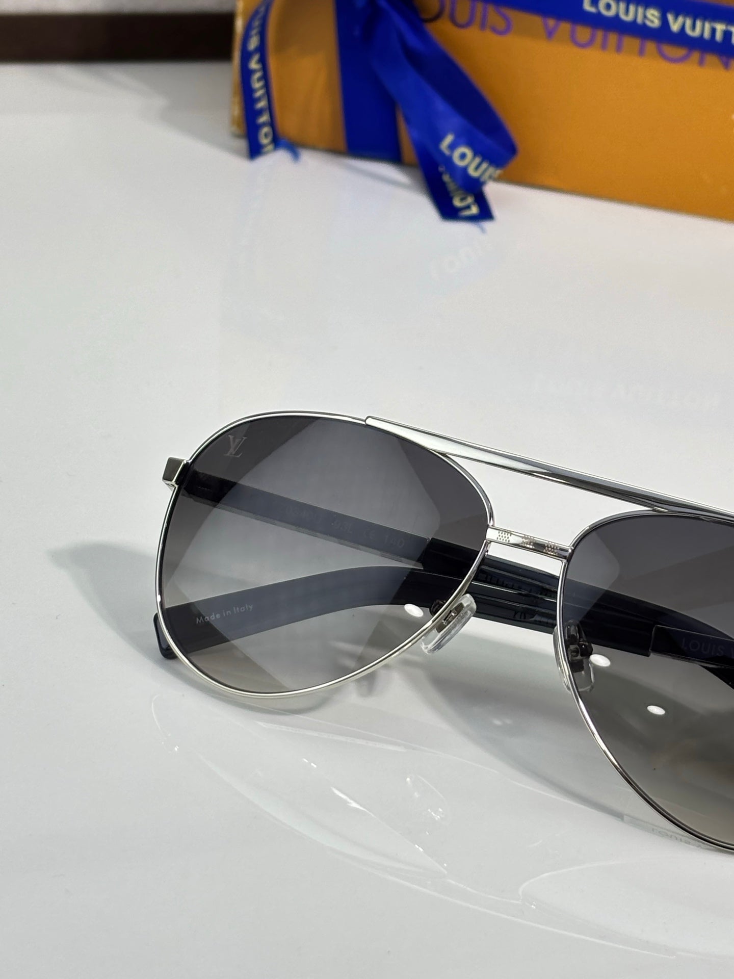 Silver-tone aviator sunglasses with dark lenses and thin metal frame