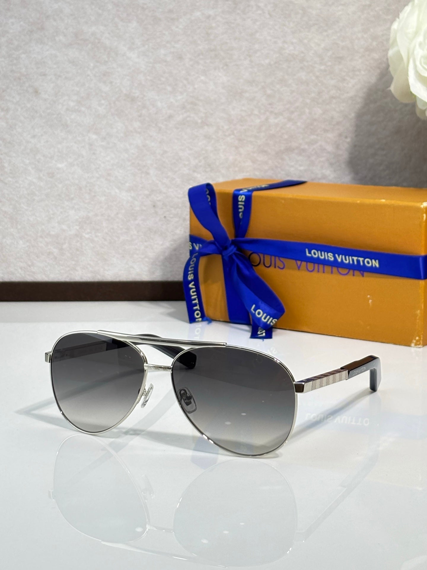 Silver-tone cat-eye sunglasses with dark gray lenses and metal temples